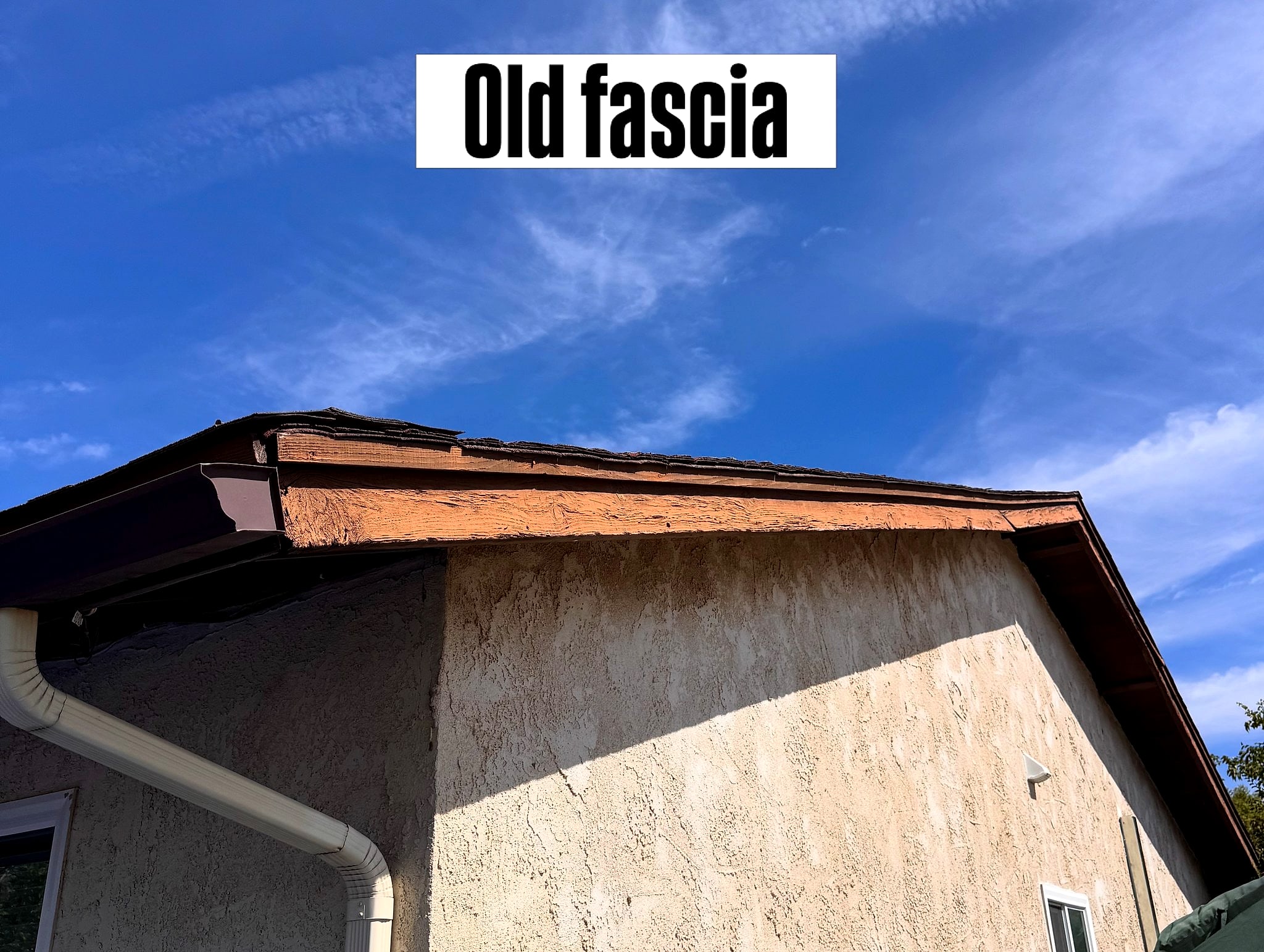 Weathered old fascia board under the roof eave