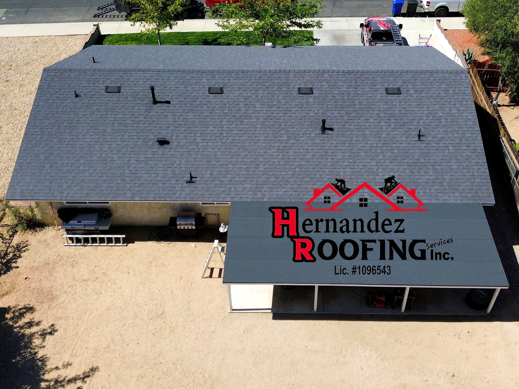 Drone view of a finished charcoal shingle re-roof on a Victorville home
