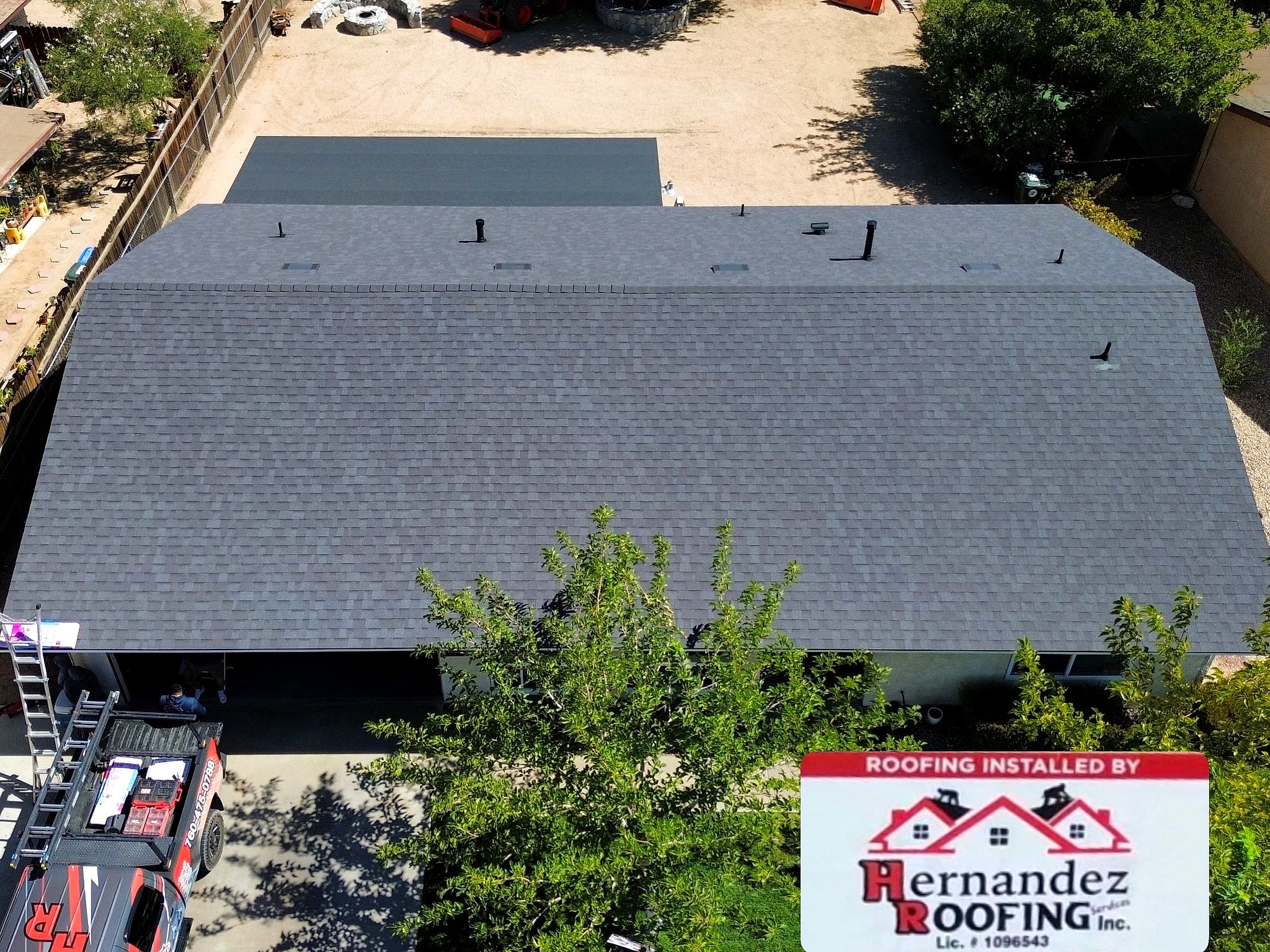 Drone view of the finished roof with the Hernandez truck and yard sign