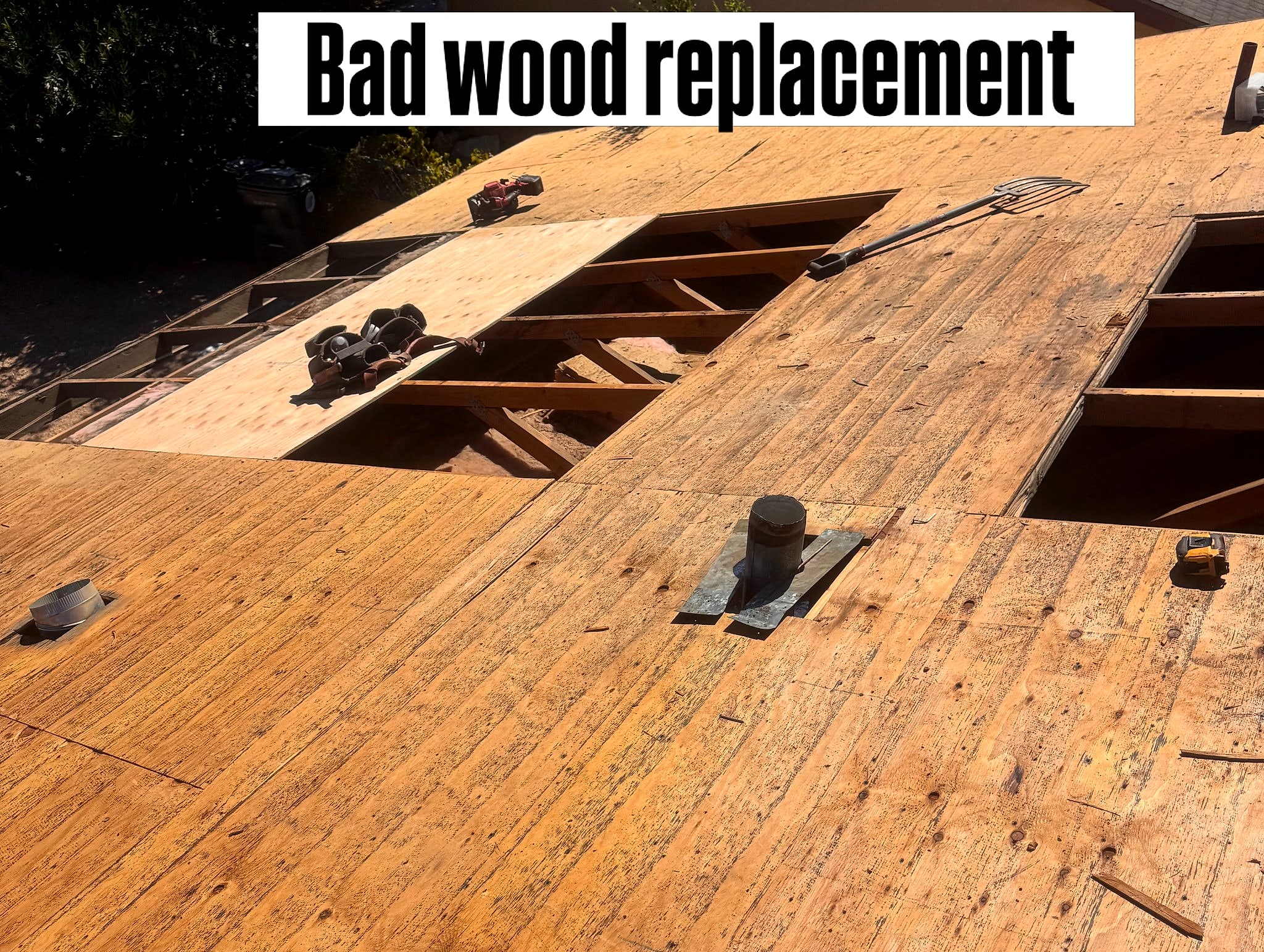 Rotten roof decking cut out, rafters showing through the openings